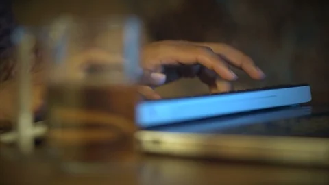 Close-up, Indian Man Typing Text On Computer Keyboard, Then Take From Table A Stock Footage 90869835