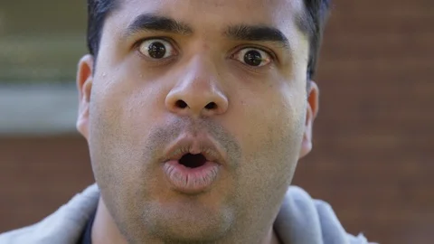 Close Up - Indian man yells into the camera in exasperation - Slow Motion - shot Stock Footage 125089387
