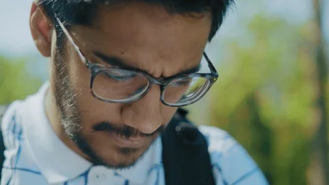 Close-up,Indian Student with Glasses Reading books in the Park Stock Footage 111103848