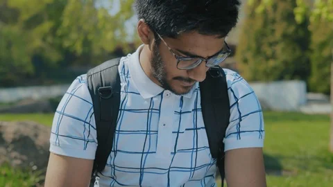 Close-Up,Indian Student with Glasses Studying Abstract, in the City Park Stock Footage 111102690