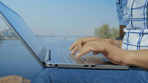 Close-up, Indian Student Hands Type Text on Laptop Keyboard on Riverbank Stock Footage 111152748