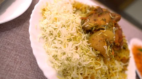 Close up of Indo Pak dessert Meetha Zarda and Chicken Sindhi Biryani Stock Footage 109080137