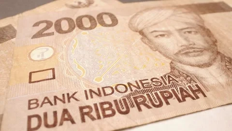 Close-up of an Indonesian 2,000-rupiah banknote with sliding motion 스톡 동영상 301445520