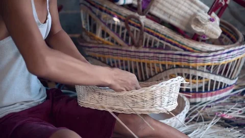 Close up of indonesian boy weaving a wicker basket Stock Footage 79142030