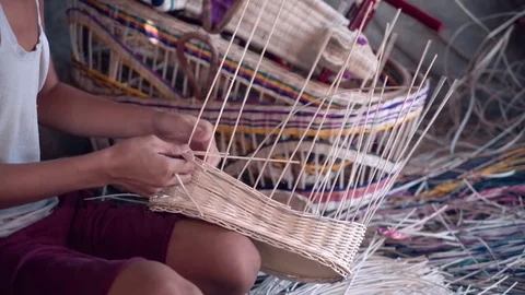Close up of indonesian boy weaving a wicker basket Stock Footage 79142297