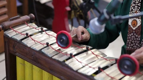 Close up of Indonesian man's hand playing traditional gamelan instrument Stock Footage 340961885