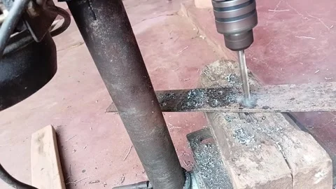 Close Up of Industrial Bench Drill Boring into Steel Metal Bar Stock Footage 330387407