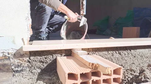 Close up of industrial bricklayer installing bricks on construction site Stock Footage 254958155
