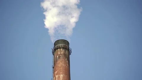 Close up of industrial chimney with emission on the background of a clear blue Stock-Footage 171371192