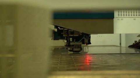 Close-up of industrial CNC laser cutting machine processing metal sheet with Stock Footage 334304674
