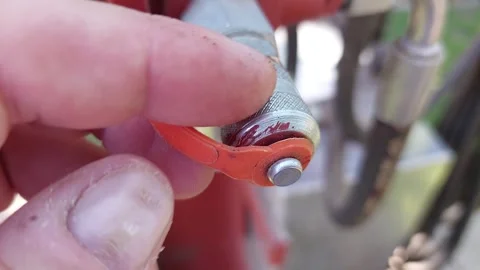 Close up of an industrial hydraulic quick coupler with a red protective cap Stock Footage 336007051