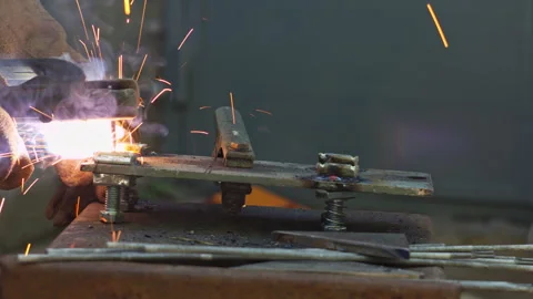 Close up of an Industrial Metal Worker Performing Manual Arc Welding Tasks Stock Footage 337431289
