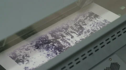 Close-up of an industrial printer printing a purple pattern. The print head Stock Footage 163077674