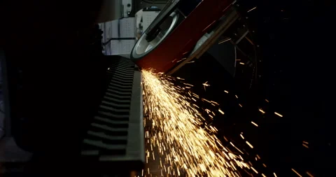 Close-up of industrial process with intense sparks flying in dark workshop Stockbeeldmateriaal 329290090
