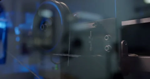 Close up of industrial rotating spool inside glass enclosure Stockbeeldmateriaal 329550891