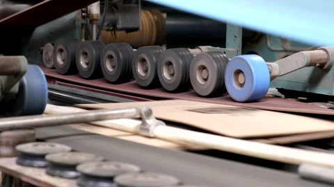Close-up of industrial rubber rollers pressing down on a conveyor belt in a.. Stock Footage 337670113