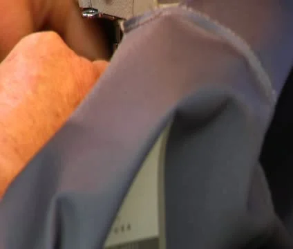 Close-up on industrial sewing machine Stock Footage 21594006