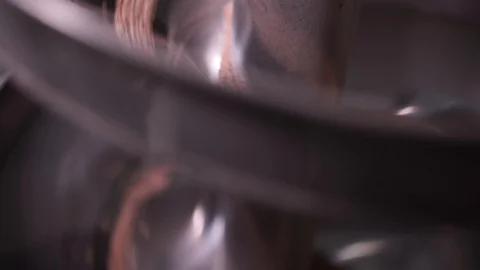 Close-up of an industrial wheat milling machine as grains spiral down 動画素材 102514623