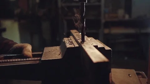 Close-up of industrial worker drilling a hole in a metal bar Video stock 70283380