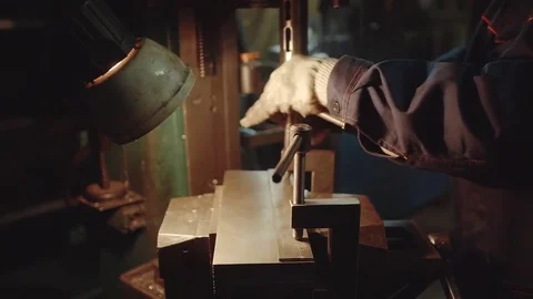 Close-up of industrial worker drilling a hole in a metal bar Stock Footage 70283528