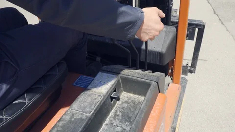 Close up industrial worker operating and driving forklift with his hand Stock Footage 130166271