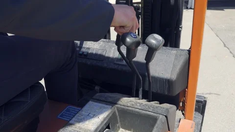 Close up industrial worker operating and driving forklift with his hand Stock Footage 130166380