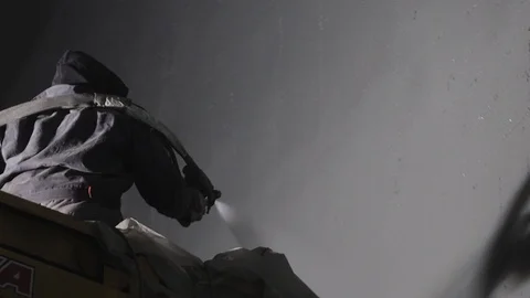 Close up: industrial worker sprays polyurea to the concrete surface with a Stock Footage 101684152