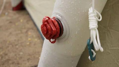 Close Up of Inflatable Tent Red Air Valve Covered in Water Droplets Stock Footage 341990246