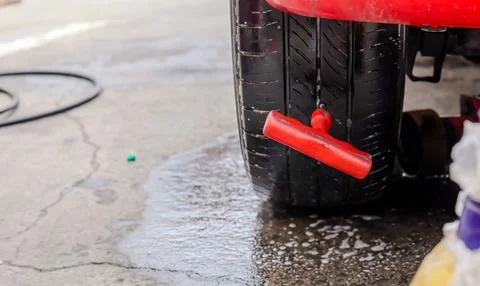 Close up inflating tire and checking air pressure with gauge pressure in se.. Stock Photos