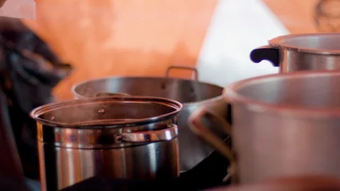 Close-Up of ingredients being added to a pot while cooking in a tent Stock Footage 113254501