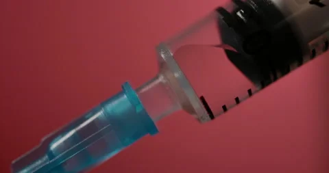 Close Up of Injection Liquid Being In Syringe Against Red Background. Medicat 스톡 동영상 165585704
