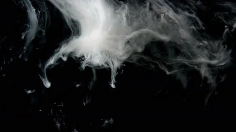 Close up of ink moving slowly in space like smoke on black background, 4k Stock Footage 67326077