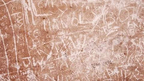 Close up of inscriptions scratched on limestone wall of ancient roman Pantheon Video stock 125755831
