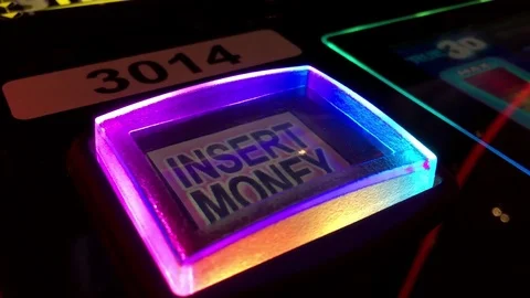 Close up insert money button on slot machine inside Hard Rock Casino Stock Footage 75403647