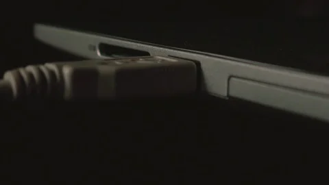 Close up insert of usb cable into laptop Stock Footage 120033030