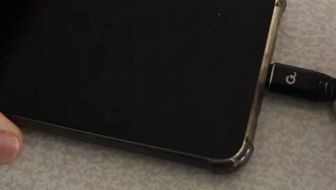 Close-Up of Inserting Charger Plug into Smartphone Stock Footage 345492713