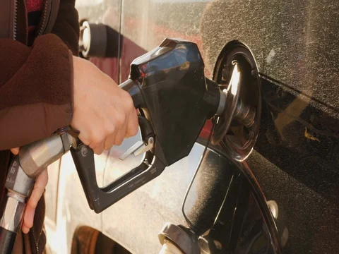 Close-up of inserting a gun for refueling a car Stock Footage 82296671