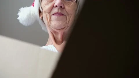 Close up inside of carton box bottom view, happy elderly woman wearing christmas Stock Footage 167238517