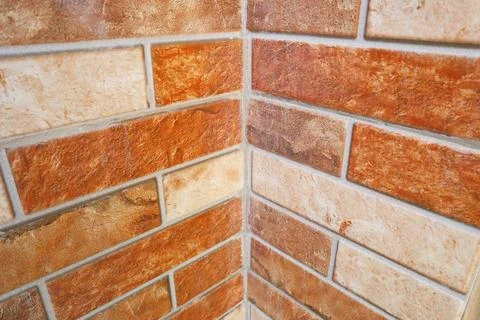 Close-up inside corner view of an orange and beige split-face decorative br.. Stock Photos