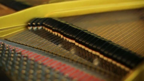 Close up of inside retro piano's hammers striking strings Stock Footage 77524817