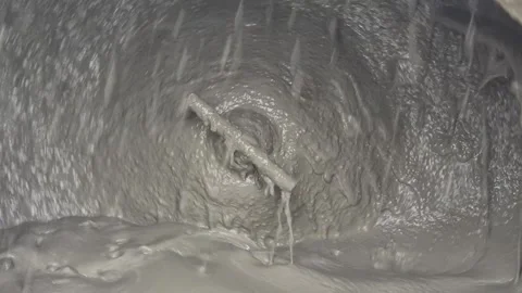 Close-up Inside a Rotating Concrete Mixer with Swirling Wet Cement - 4K Stock Footage 331702246
