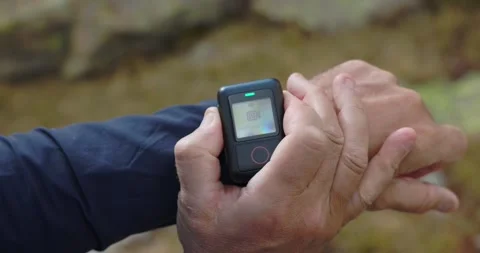 Close up Insta360 GPS remote device on wrist, hand presses buttons Stock Footage 295177295