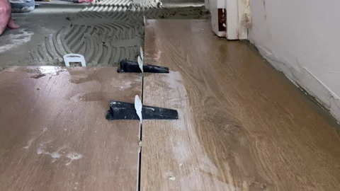 Close up. Installing ceramic floor tiles.  Construction, renovation, repair Stock Footage 153802666