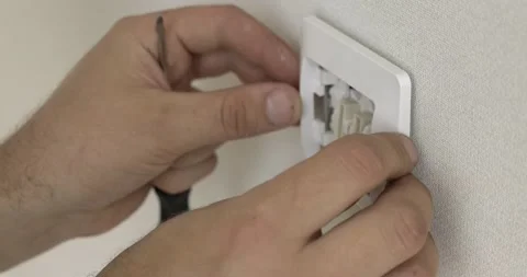 Close-up of installing switch, installing decorative white frame, two-key switch Stock Footage 131182032