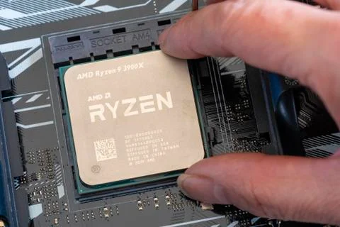 Close-up of installing third generation Ryzen processor on mainboard Stock Photos