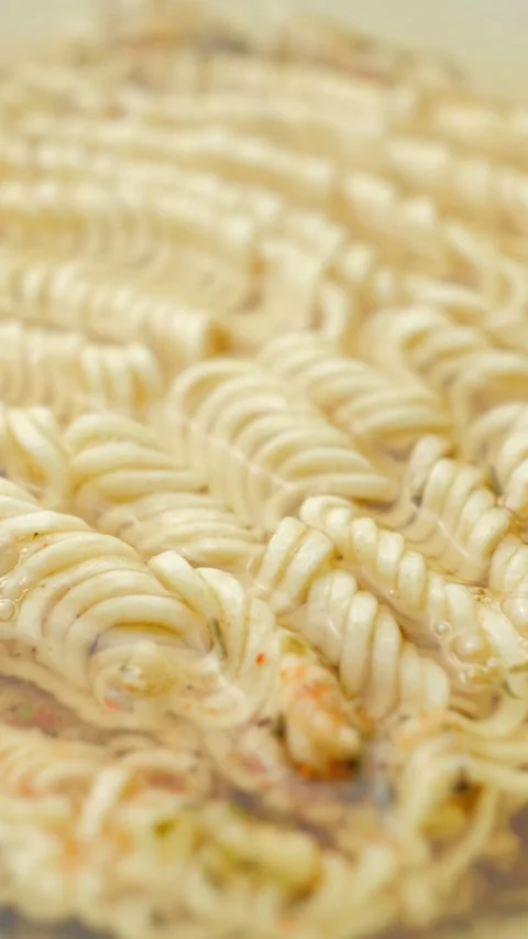 Close-up of instant noodles brewing and softening in hot water Stock Footage 346604520