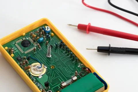 Close-up of the integrated circuit of a tester with the test leads on white Stock Photos