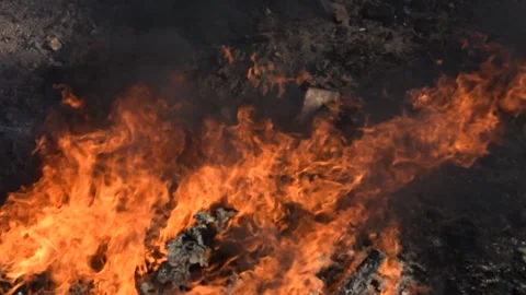 Close-up of Intense Fire Burning Debris and Rubbish Stock Footage 325791435