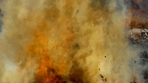 Close up-Intense flames and orange smoke rage skyward Stock Footage 98329338