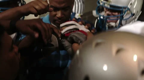 Close up of an intense huddle getting amped before a football game Video stock 33871250